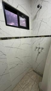 a bathroom with a shower and a window at Lo de jota in Ramallo