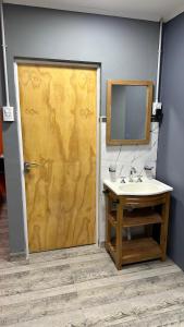 a bathroom with a shower with a sink and a mirror at Lo de jota in Ramallo