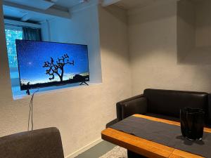 a dining room with a table and a picture of a tree at Fantastic Apartment Tromsø Two in Tromsø