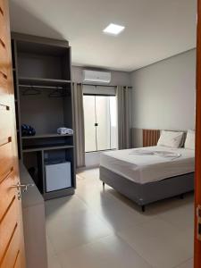 a bedroom with a bed and a large window at Rosmarry Hotel in Colinas do Tocantins