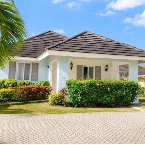 a house with a palm tree in front of it at Willis staycation in Sandy Bay