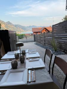 a table with plates and utensils on a patio at Casa Amor Iseo Lake in Riva di Solto