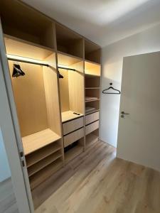a walk in closet with wooden cabinets and a door at Villa Danni in Quiberon +8 photos