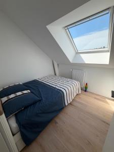 a bedroom with a bed and a large window at Villa Danni in Quiberon