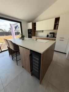 a kitchen with a large island in the middle at Villa Danni in Quiberon