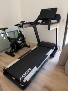 a treadmill in a living room next to a couch at Villa Danni in Quiberon