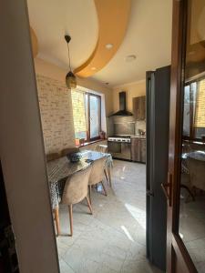 a kitchen and dining room with a table and chairs at home 4 room in Yerevan