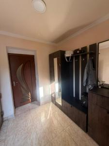 a large room with a door and a tile floor at home 4 room in Yerevan +11 photos
