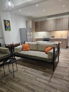 a living room with a couch and a kitchen at Aspa's house in Athens
