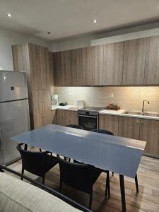 a kitchen with a large blue table and chairs at Aspa's house in Athens