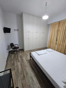 a room with a bed and a chair in it at Aspa's house in Athens