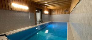 a large swimming pool in a room with at Utoring Acletta B 27 in Disentis