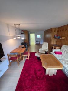 a living room with a couch and a table at Utoring Acletta B 27 in Disentis