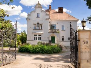 an old house with a gate in front of it at Willa Wiluszówka in Dębica +21 photos