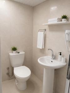 a white bathroom with a toilet and a sink at The Selection Butik Otel in Kemer +26 photos