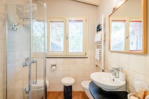 a bathroom with a sink toilet and a shower at B&B Kapì Country in Alghero