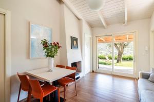 a living room with a table and chairs and a couch at B&B Kapì Country in Alghero
