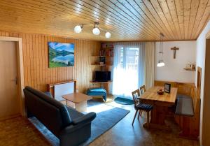 a living room with a couch and a table at Chalet Alpenheim 1 OG in Bettmeralp
