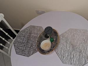 a table with a bowl of food on top of it at Shalom - Stays in Voi