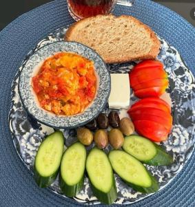 a plate of food with eggs and bread and vegetables at The Selection Butik Otel in Kemer