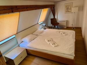 a bedroom with a large bed with white sheets at Residence Mutschellen in Zurich