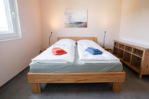 a bedroom with a bed with two towels on it at Haus Freija in Sehestedt