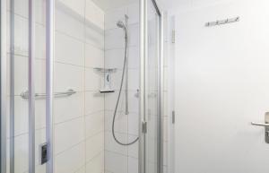 a bathroom with a shower with a glass door at Chalet Alpenheim 1 OG in Bettmeralp +3 photos