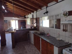 a kitchen with a sink and a counter top at Cabaña Paralelo 1 in Viedma