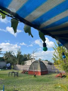 a tent and a picnic table in a field at Ayira Campsite in Vilankulo Airport