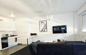 a living room with a couch and a table at Suite Studio Moderne Quartier du Flon in Lausanne