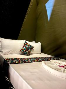 two beds with pillows sitting next to each other at Ayira Campsite in Vilankulo Airport