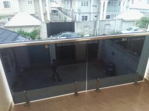 a view of a balcony with a person walking on the floor at Service Apartment in Okunola