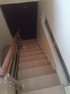 a staircase in a building with a stair case at Service Apartment in Okunola