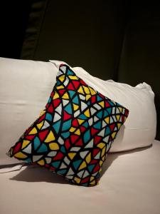 a colorful pillow sitting on top of a bed at Ayira Campsite in Vilankulo Airport