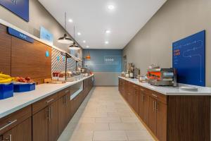 a large kitchen with wooden cabinets and a counter at Holiday Inn Express Breezewood by IHG in Breezewood