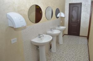 a bathroom with two sinks and mirrors on the wall at Hostel East Star Khiva in Khiva +39 photos