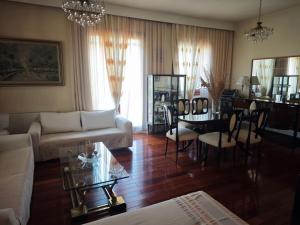 a living room with a couch and a table at Red House Retreat Aegina Kontos in Kondós
