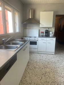 a kitchen with a sink and a stove top oven at Belle vue étoilée in Saint-Ouen +18 photos