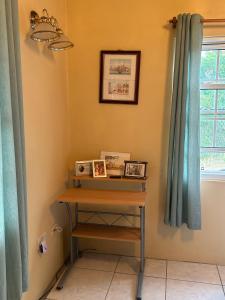a small table in a room with a window at Amazing Antigua Getway in Bolans