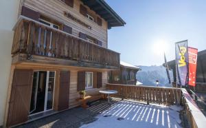 a balcony of a building with a table on it at Chalet Alpenheim 1 OG in Bettmeralp