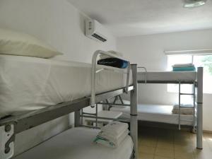 a room with two bunk beds and a window at Casa Laurel in Cancún