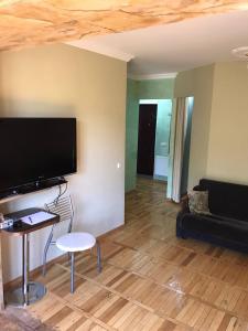 a living room with a flat screen tv and a couch at Jermuk in Jermuk