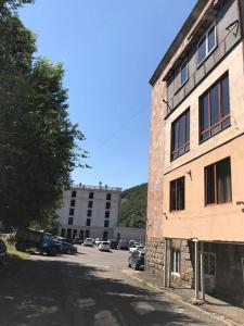 a building with cars parked in a parking lot at Jermuk in Jermuk