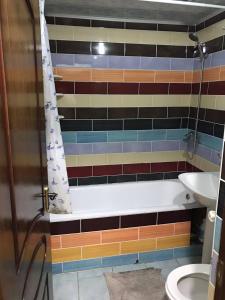 a bathroom with a tub and a sink and a toilet at Jermuk in Jermuk