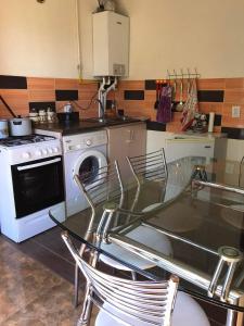 a kitchen with a table and chairs and a stove at Jermuk in Jermuk