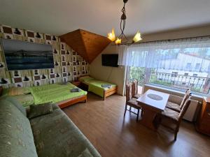 a living room with a couch and a table at Pensjonat Krystian in Chmielno