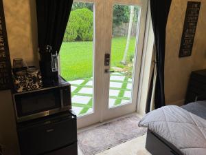 a bedroom with a door leading to a yard at Homestay Weston Ranches in Southwest Ranches
