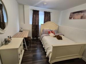 a bedroom with a bed with a teddy bear on it at Home Sweet Home in Red Deer