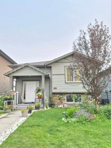 a house with a yard with a lawn sidx sidx sidx at Home Sweet Home in Red Deer