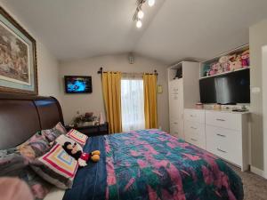 a bedroom with a bed with a teddy bear on it at Home Sweet Home in Red Deer